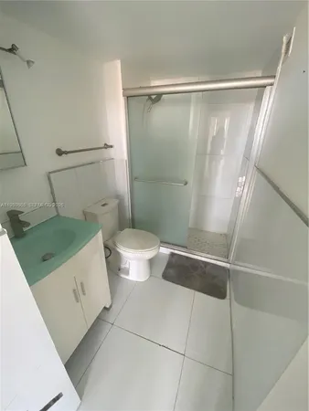 a bathroom with a glass shower door