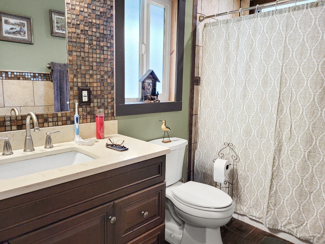 18-8079 North Kulani Road Mountain View, HI 96771 - Photo 13 of 27 a bathroom with a sink and a toilet