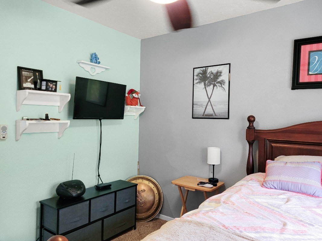 18-8079 North Kulani Road Mountain View, HI 96771 - Photo 14 of 27 a bedroom with a bed and a flat screen tv