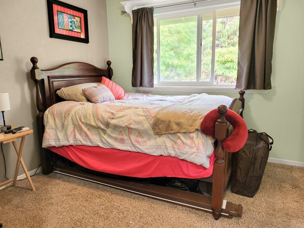 18-8079 North Kulani Road Mountain View, HI 96771 - Photo 15 of 27 a bedroom with a bed and a window