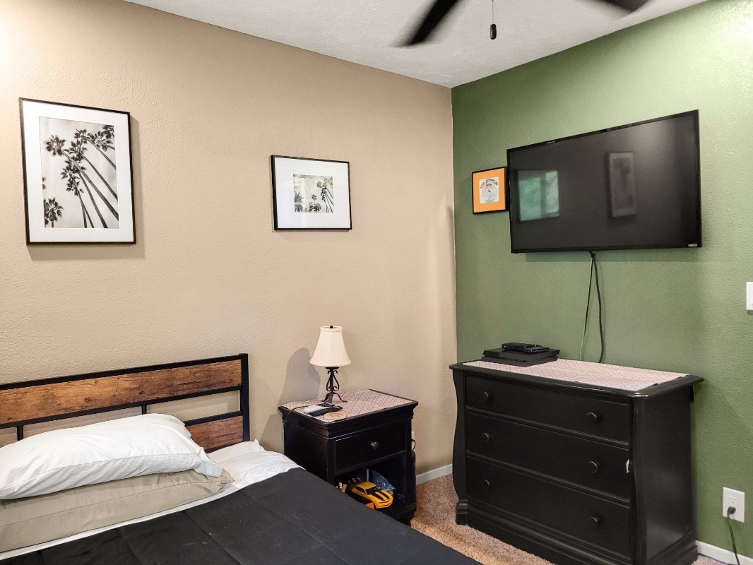 18-8079 North Kulani Road Mountain View, HI 96771 - Photo 16 of 27 a bedroom with a bed and a lamp on table