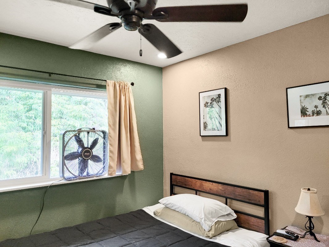 18-8079 North Kulani Road Mountain View, HI 96771 - Photo 18 of 27 a bedroom with a bed and window