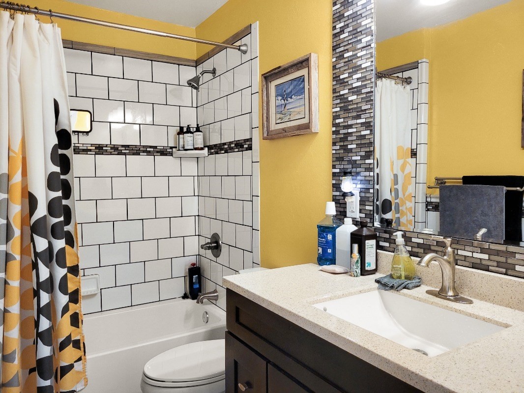 18-8079 North Kulani Road Mountain View, HI 96771 - Photo 19 of 27 a bathroom with a sink toilet vanity and shower