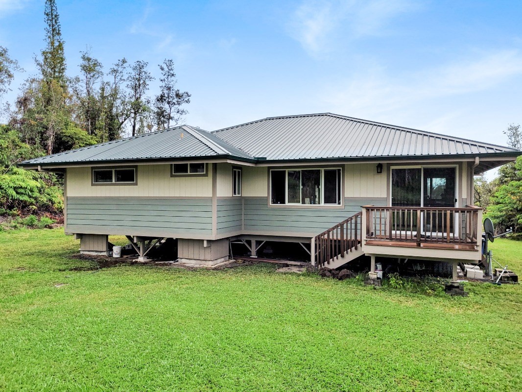 18-8079 North Kulani Road Mountain View, HI 96771 - Photo 2 of 27 a backyard of a house with table and chairs