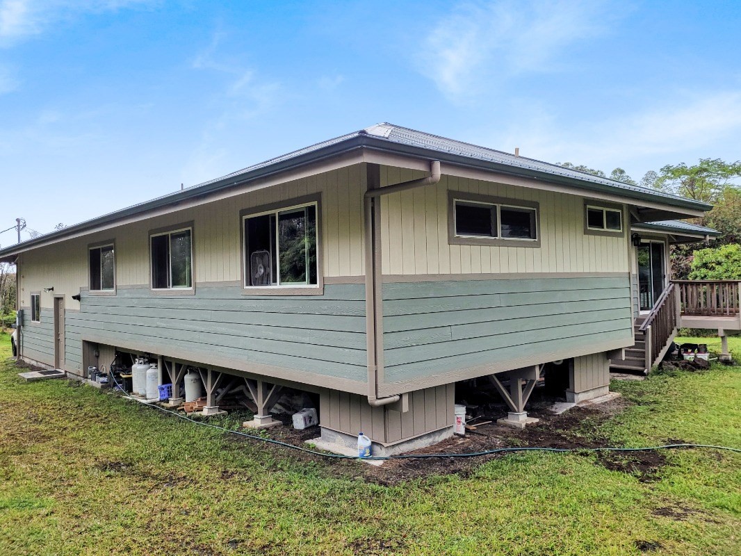18-8079 North Kulani Road Mountain View, HI 96771 - Photo 3 of 27 a view of a house with a yard and wooden fence