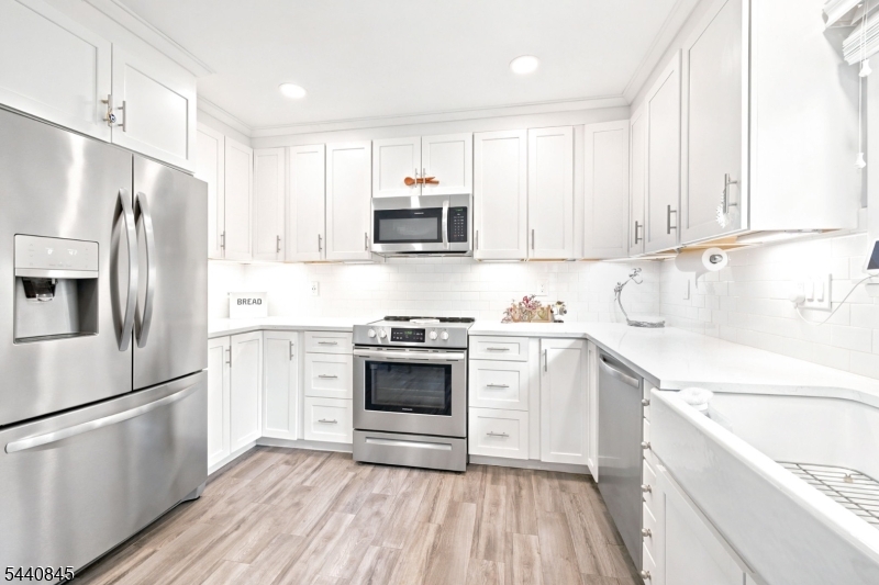 36 Forest Road Andover, NJ 07821 - Photo 28 of 50 a kitchen with a refrigerator stove and white cabinets