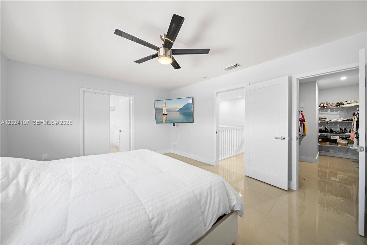 15341 Southwest 36th Street Miami, FL 33185 - Photo 15 of 56 a bedroom with a large bed and closet
