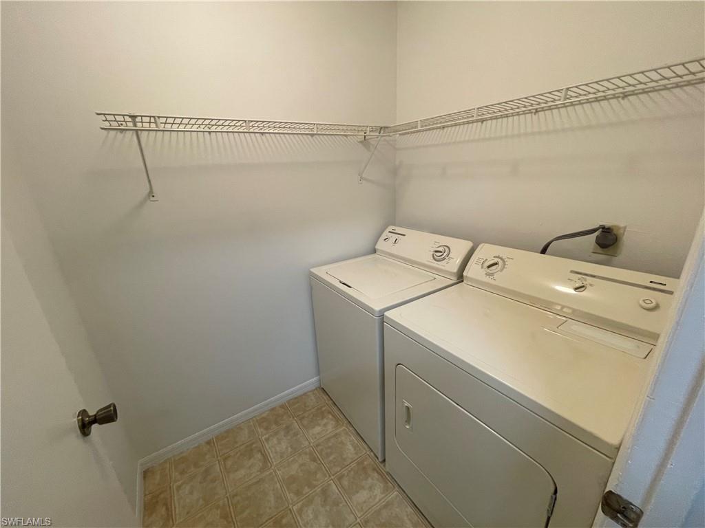 2142 Arbour Walk Circle, Unit 2624 Naples, FL 34109 - Photo 12 of 13 a utility room with dryer and washer