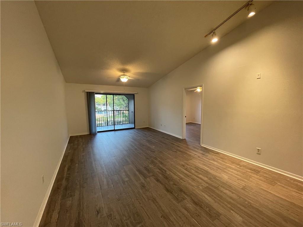 2142 Arbour Walk Circle, Unit 2624 Naples, FL 34109 - Photo 2 of 13 an empty room with wooden floor and windows