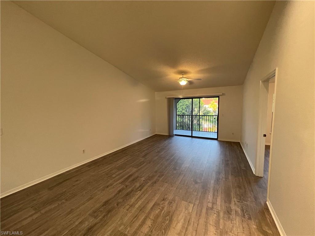 2142 Arbour Walk Circle, Unit 2624 Naples, FL 34109 - Photo 3 of 13 an empty room with wooden floor and windows