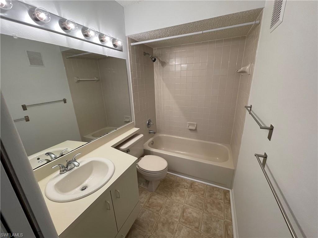 2142 Arbour Walk Circle, Unit 2624 Naples, FL 34109 - Photo 6 of 13 a bathroom with a sink a toilet and shower