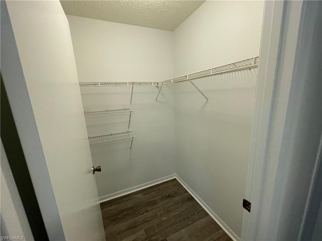 2142 Arbour Walk Circle, Unit 2624 Naples, FL 34109 - Photo 8 of 13 a view of an empty walk in closet