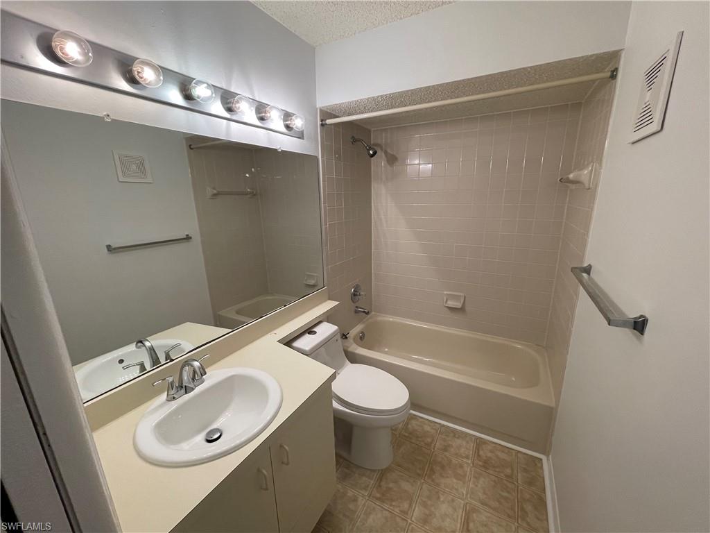 2142 Arbour Walk Circle, Unit 2624 Naples, FL 34109 - Photo 9 of 13 a bathroom with a sink a toilet and shower