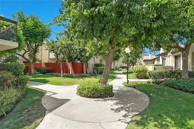 a front view of a house with a yard and a garden