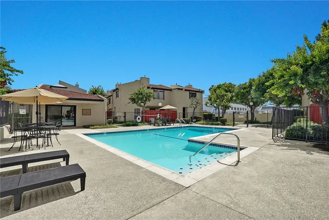 a view of a house with swimming pool and sitting area