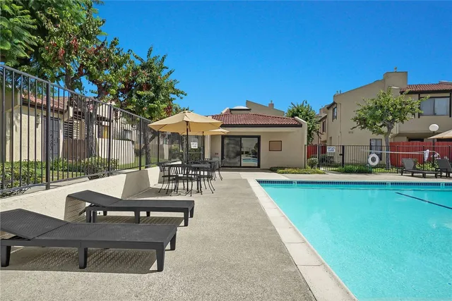 a view of swimming pool with outdoor seating and a garden