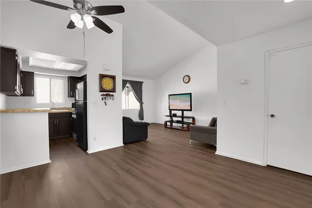 a living room with furniture and a kitchen