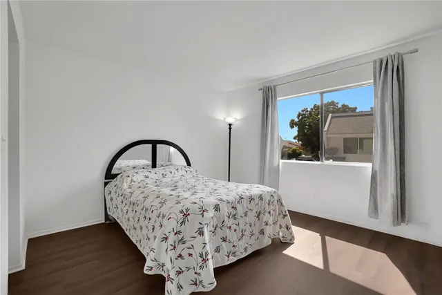 a bedroom with a bed and a large window