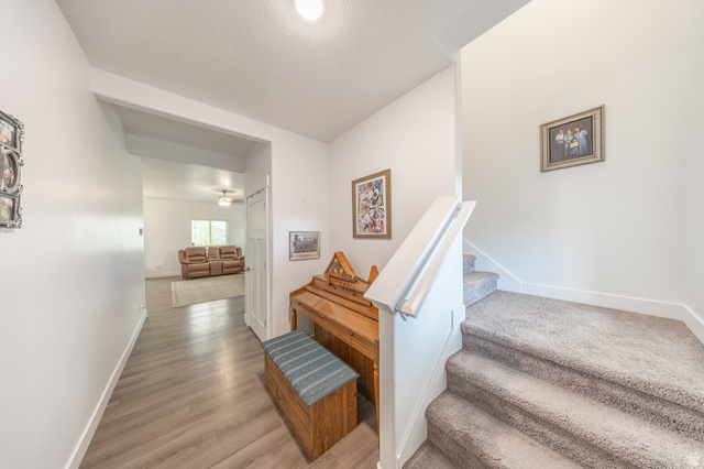 4765 Breezy Patch Road Eagle Mountain, UT 84005 - Photo 5 of 25 Hallway with wood-finish flooring extending into an open living area