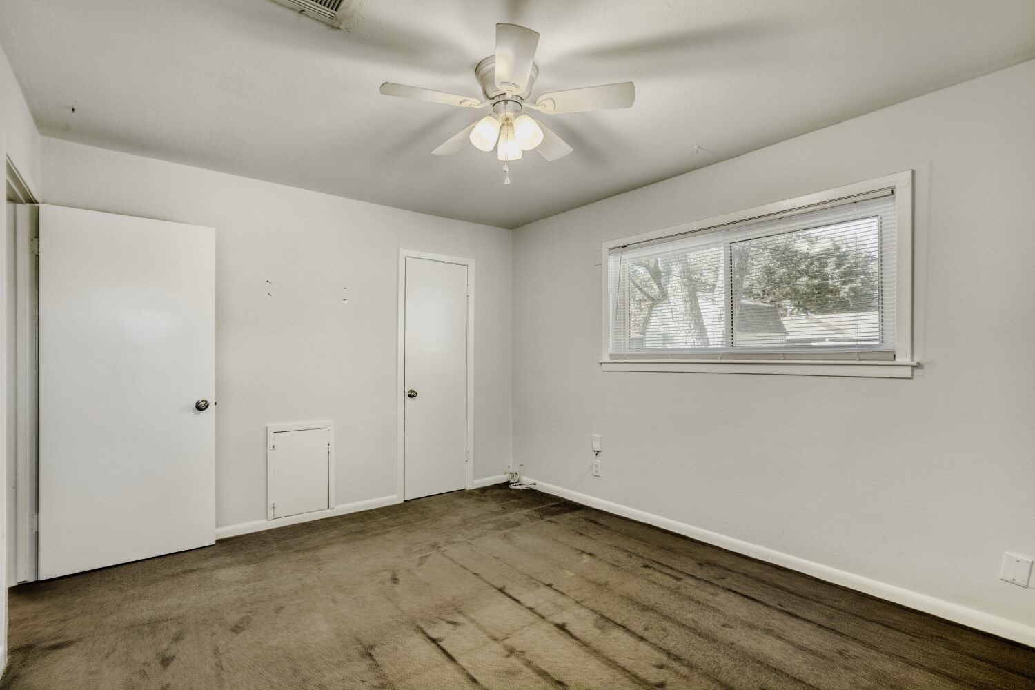 5014 Viking Drive Houston, TX 77092 - Photo 22 of 30 a view of an empty room with a window and a fan