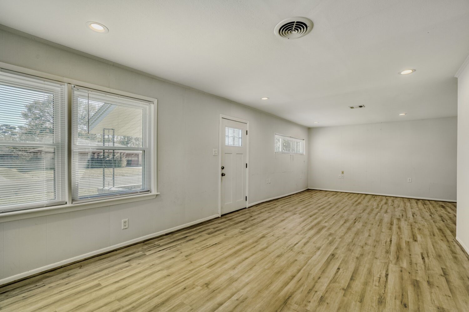 5014 Viking Drive Houston, TX 77092 - Photo 7 of 30 an empty room with wooden floor and windows