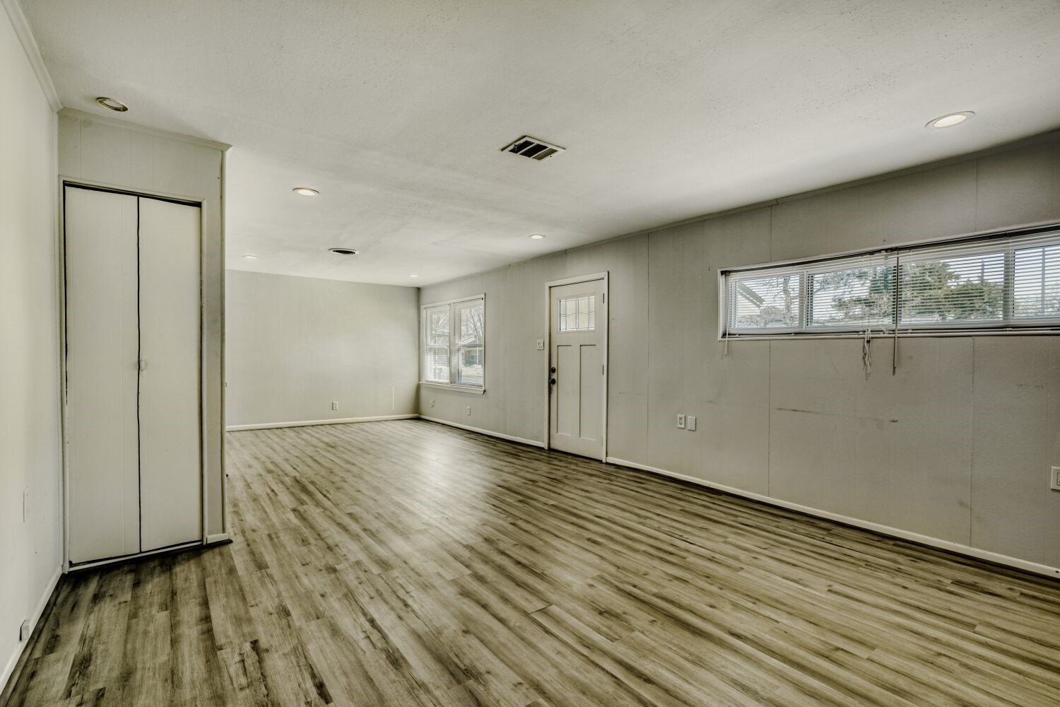 5014 Viking Drive Houston, TX 77092 - Photo 9 of 30 a view of an empty room with wooden floor and a window