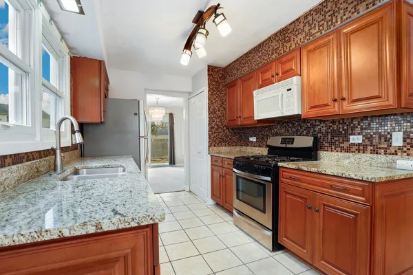 a kitchen with a sink stove and cabinets