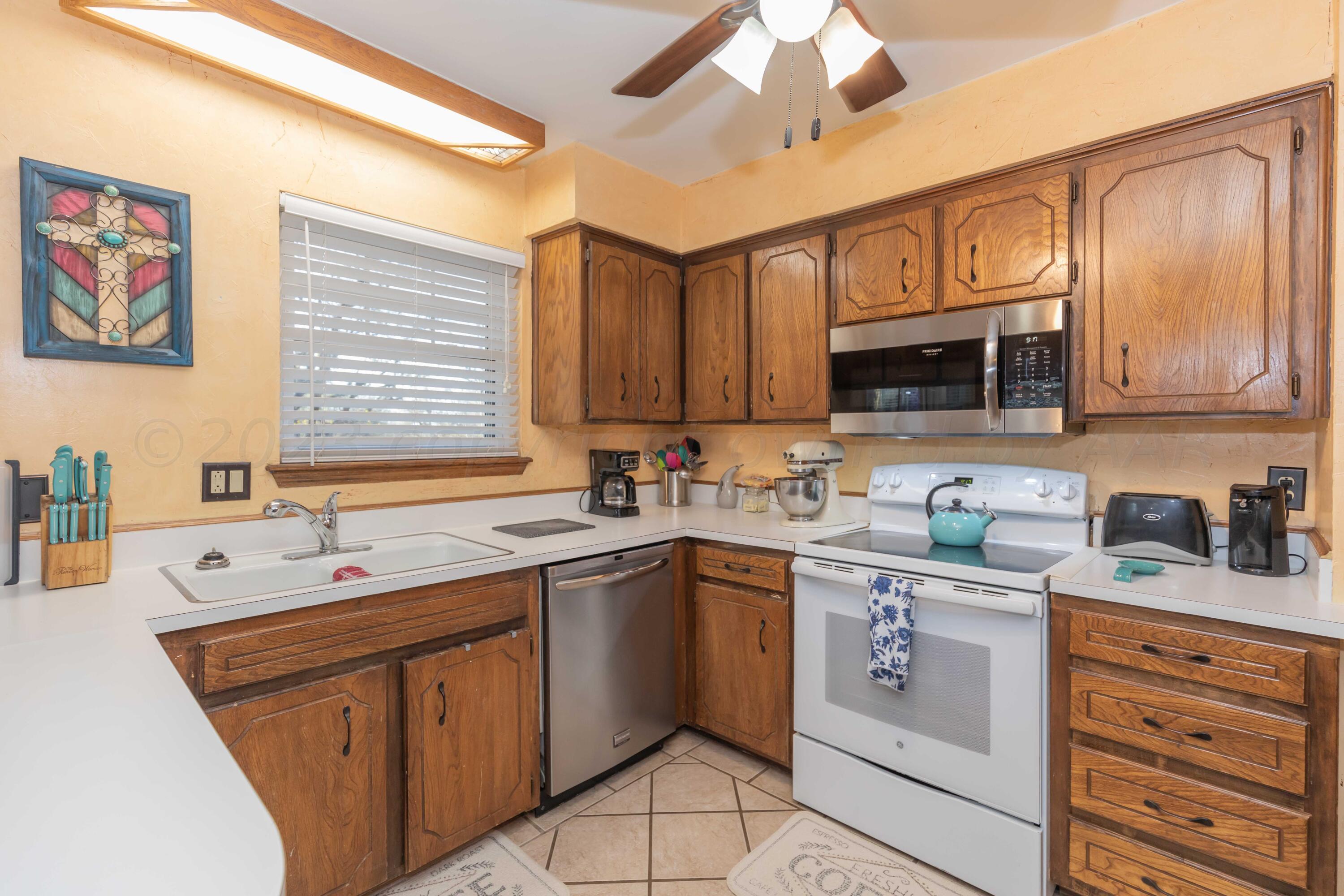 2805 Shield Court Amarillo, TX 79110 - Photo 11 of 36 a kitchen with stainless steel appliances granite countertop a sink stove microwave and cabinets