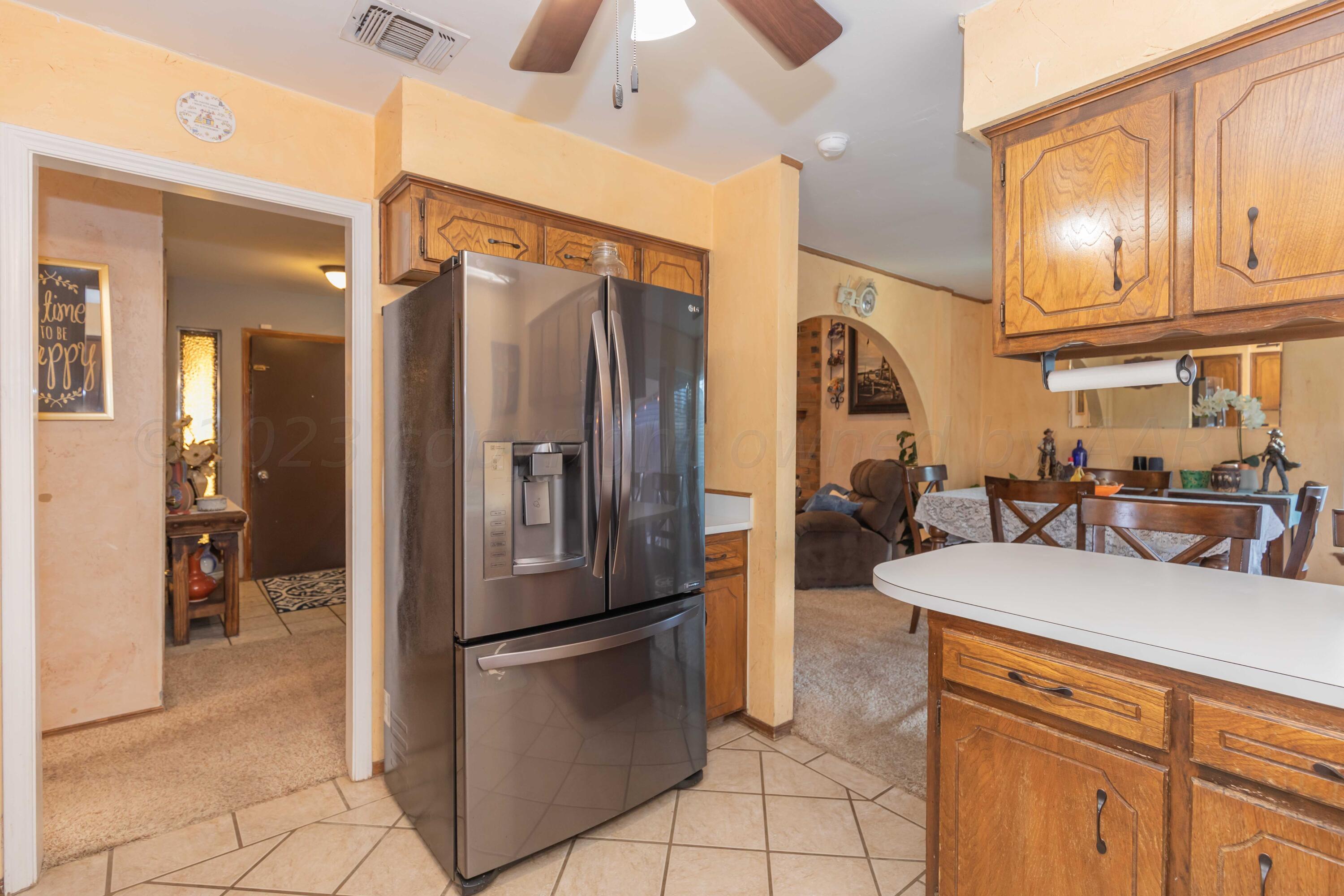 2805 Shield Court Amarillo, TX 79110 - Photo 12 of 36 a kitchen with stainless steel appliances granite countertop a refrigerator a sink and white cabinets
