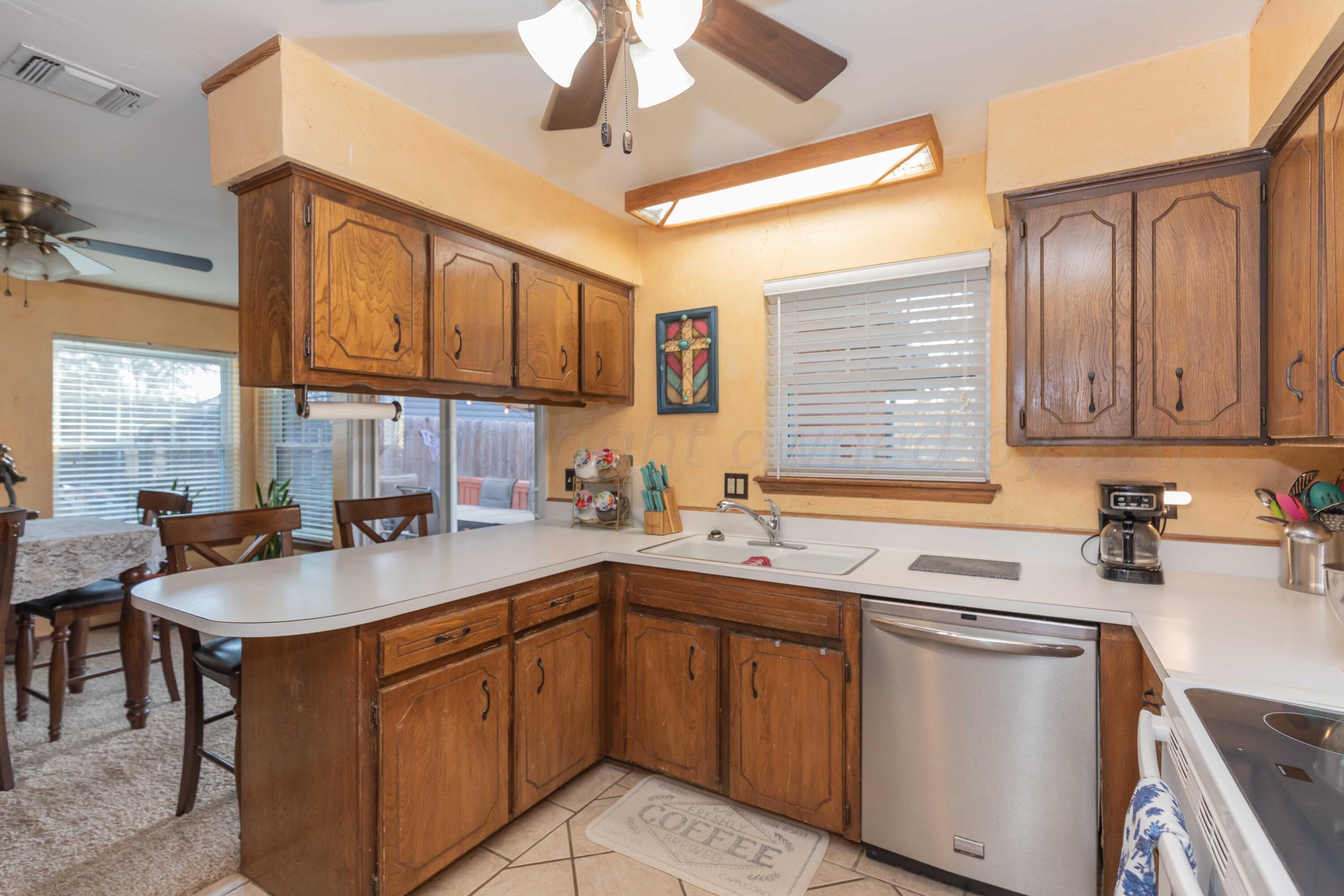 2805 Shield Court Amarillo, TX 79110 - Photo 13 of 36 a kitchen with stainless steel appliances granite countertop a sink stove cabinets and window
