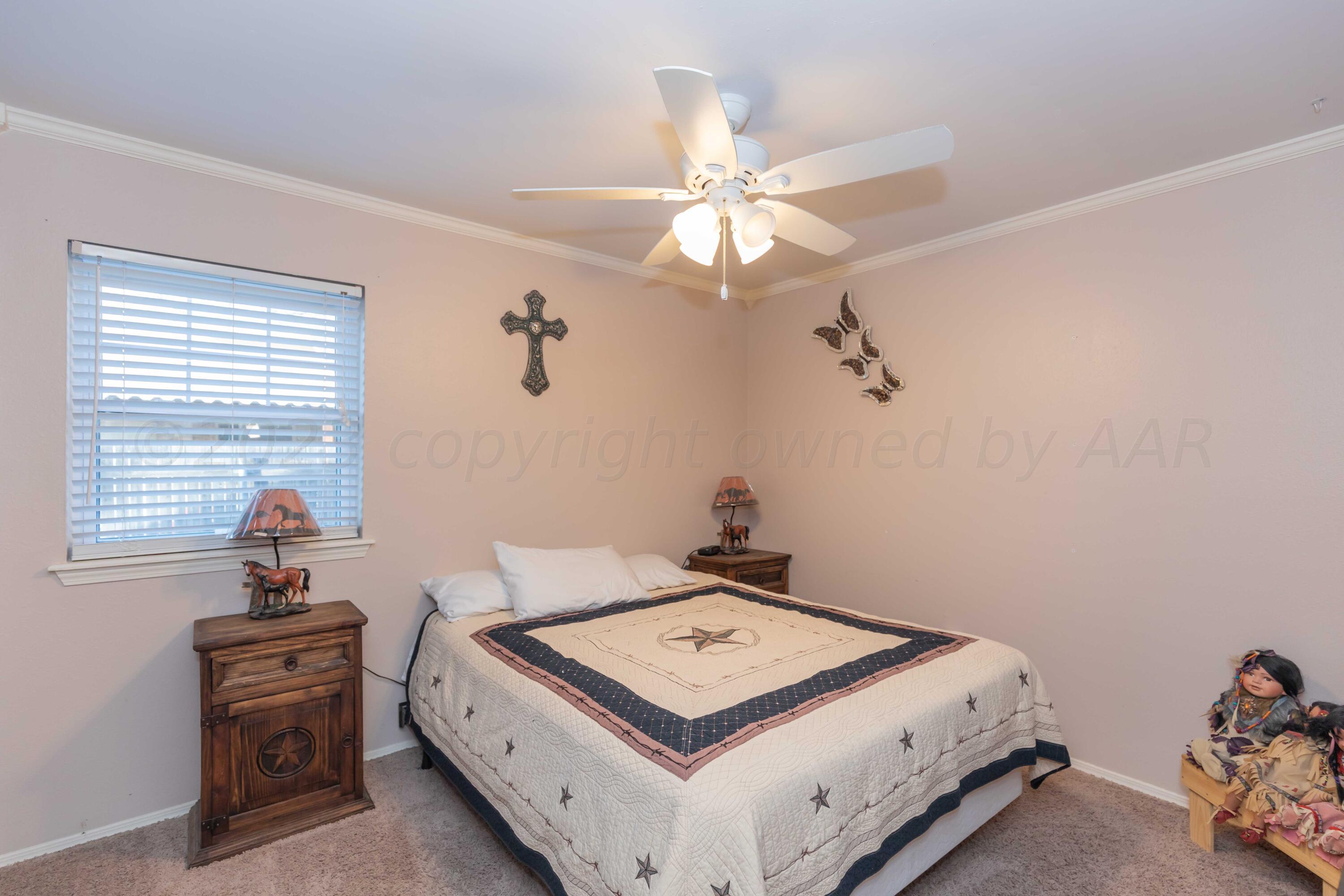 2805 Shield Court Amarillo, TX 79110 - Photo 20 of 36 a bedroom with a bed and a chandelier