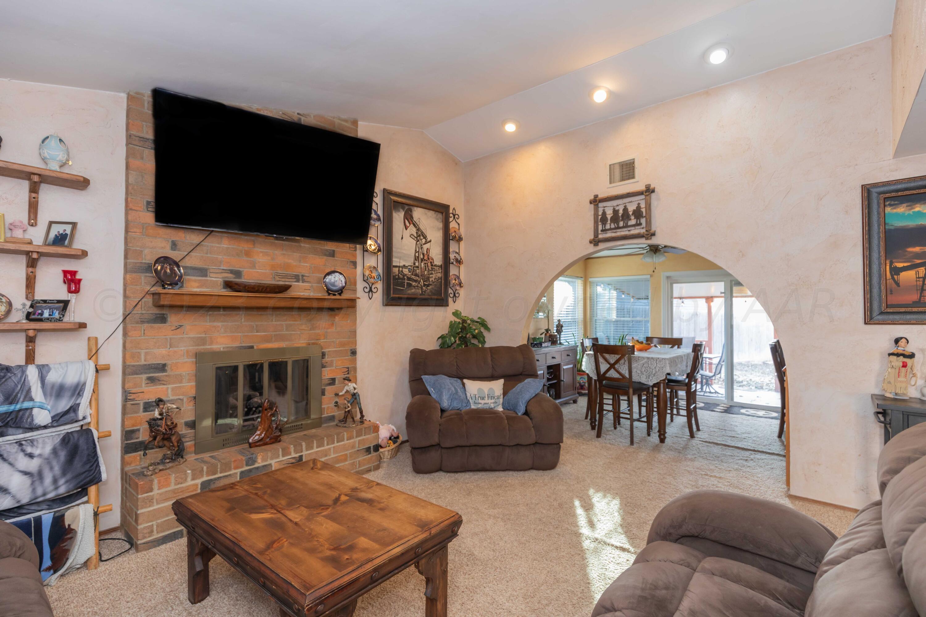 2805 Shield Court Amarillo, TX 79110 - Photo 4 of 36 a living room with furniture a flat screen tv and a fireplace