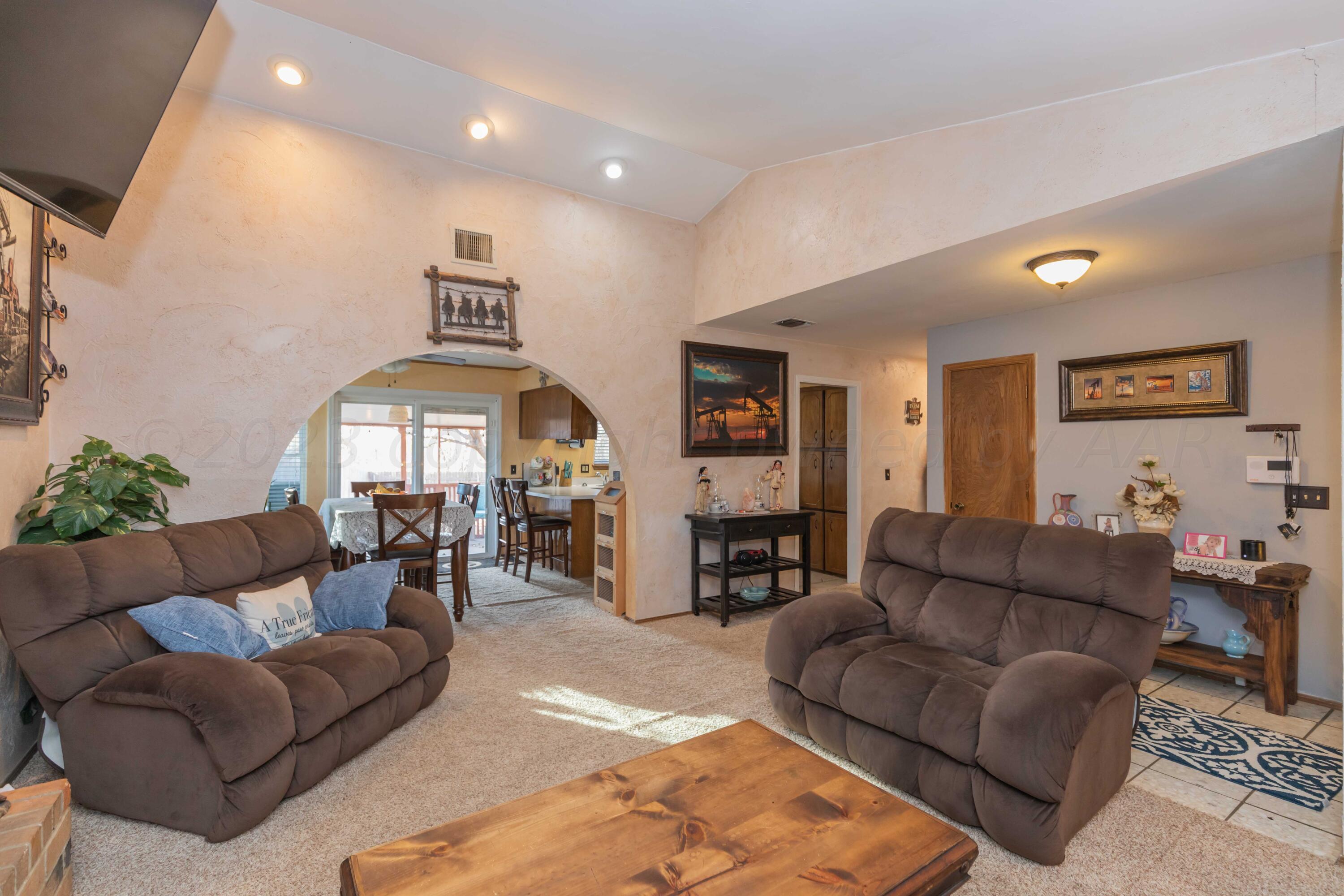 2805 Shield Court Amarillo, TX 79110 - Photo 7 of 36 a living room with furniture and a fireplace