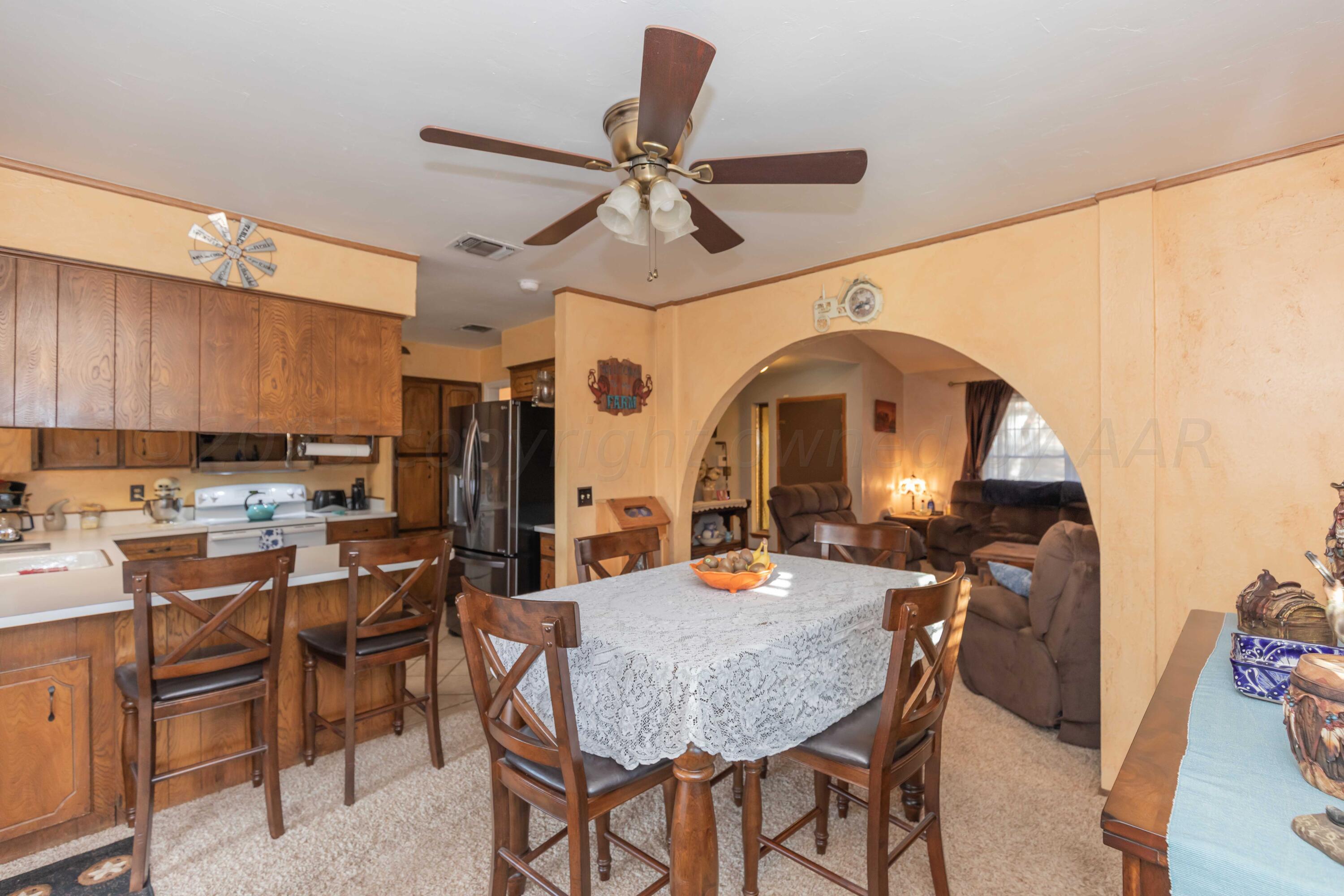 2805 Shield Court Amarillo, TX 79110 - Photo 10 of 36 a view of a dining room with furniture and a chandelier