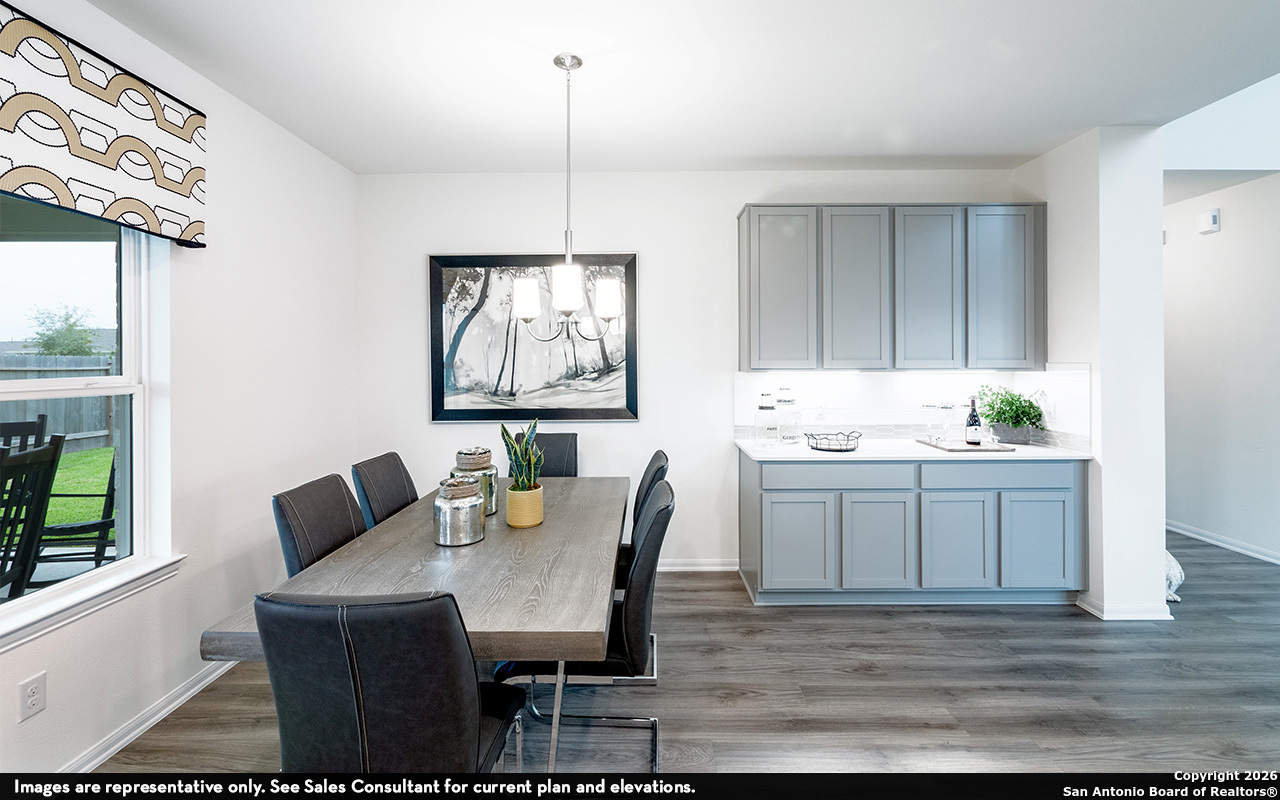 9005 Hazel Birch Elmendorf, TX 78112 - Photo 11 of 21 a kitchen with granite countertop a table chairs stove and sink