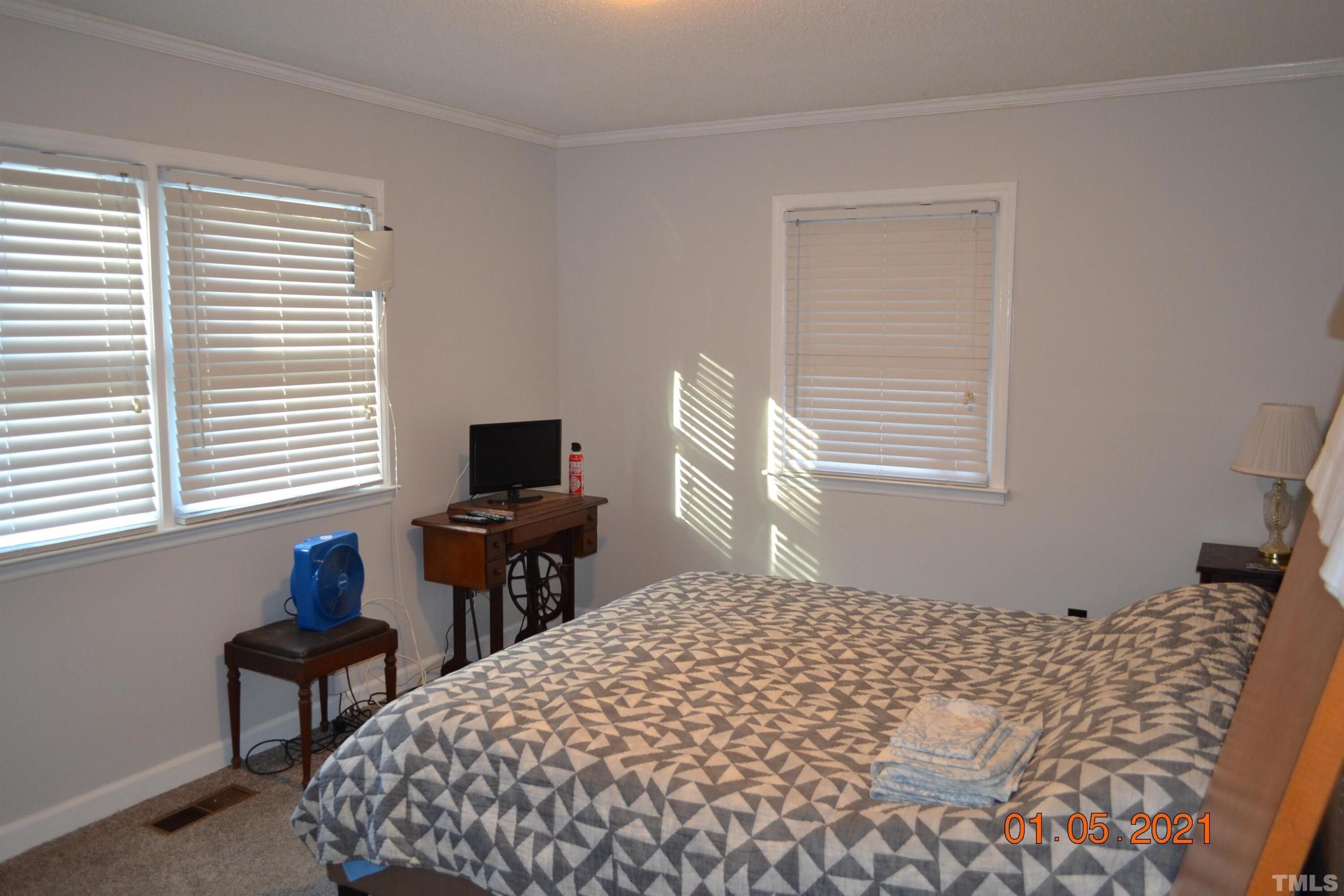 2015 Piney Plains Road Cary, NC 27518 - Photo 25 of 27 a bedroom with a bed and a window