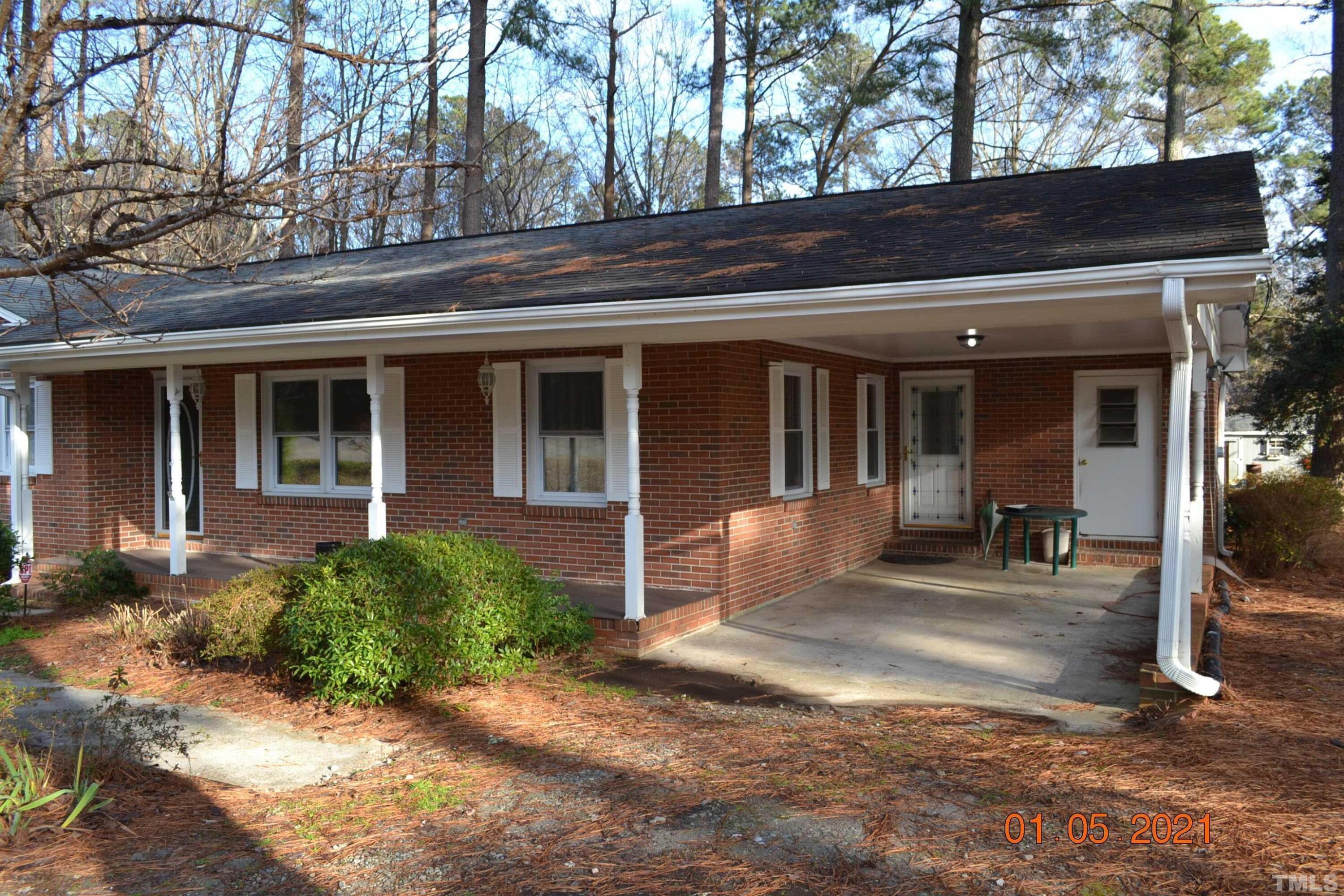 2015 Piney Plains Road Cary, NC 27518 - Photo 3 of 27 a view of a house with backyard porch and sitting area