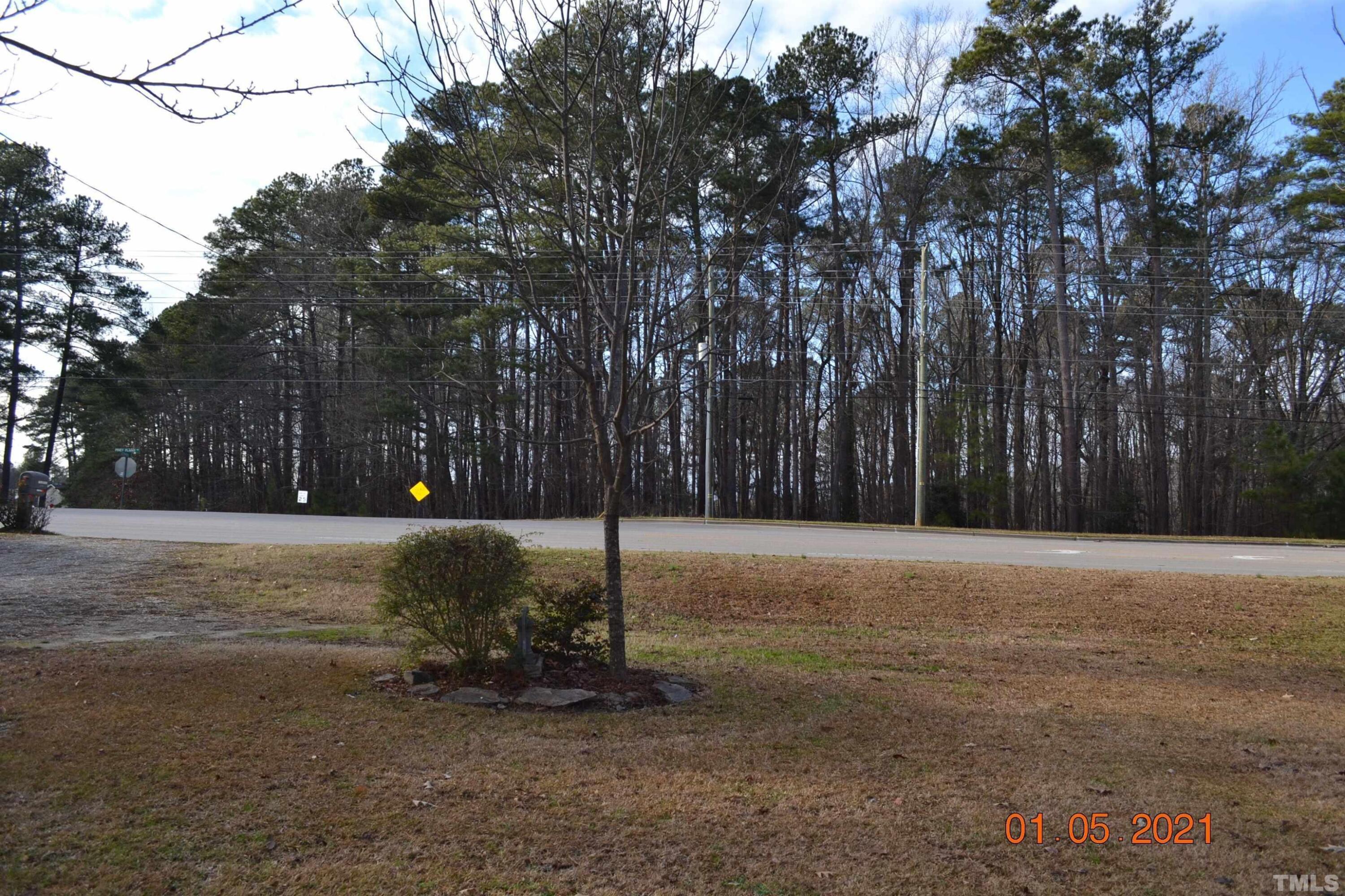 2015 Piney Plains Road Cary, NC 27518 - Photo 4 of 27 a backyard of a house with trees