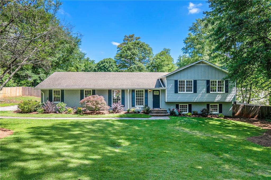 528 Chestnut Hill Road Southwest Marietta, GA 30064 - Photo 1 of 1 a front view of a house with a yard and trees