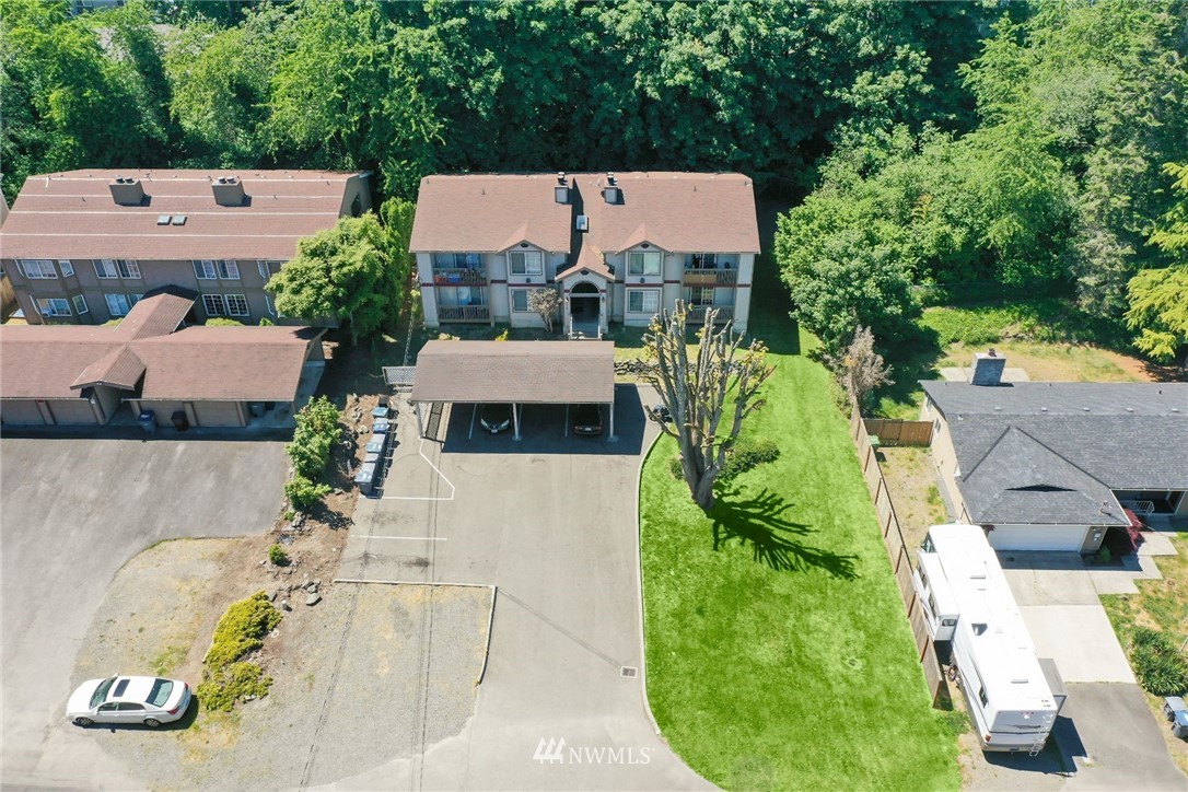 3118 Morrison Road West, Unit AD University Place, WA 98466 - Photo 2 of 11 an aerial view of a house with swimming pool and large trees