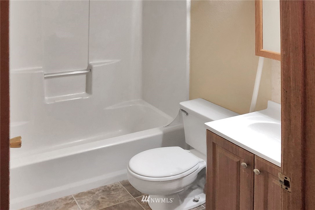 3118 Morrison Road West, Unit AD University Place, WA 98466 - Photo 6 of 11 a white toilet sitting next to a bath tub