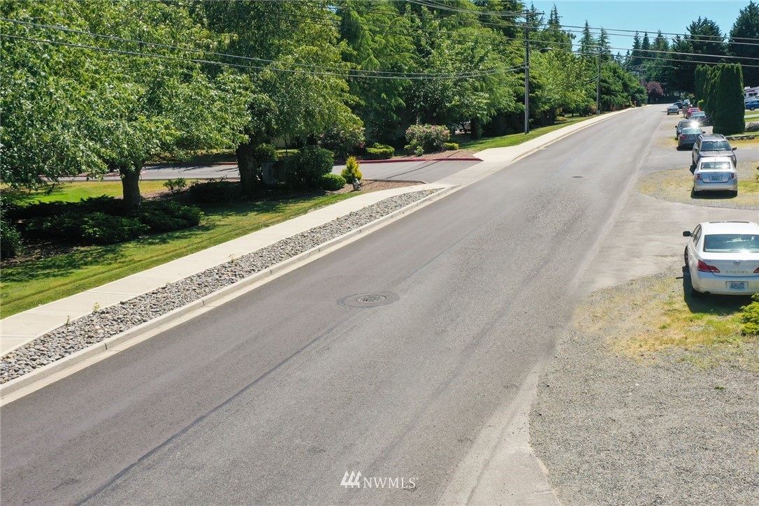 3118 Morrison Road West, Unit AD University Place, WA 98466 - Photo 8 of 11 a view of a road with a car parked beside