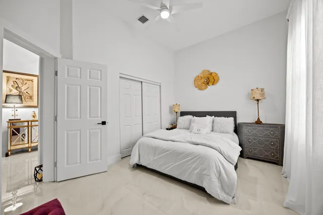 a bedroom with a bed and a window