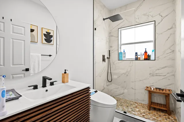 a bathroom with a sink toilet and window