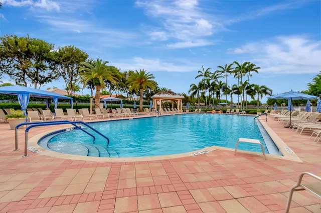 a view of swimming pool with outdoor seating and plants