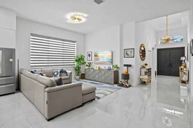 a living room with furniture and a chandelier