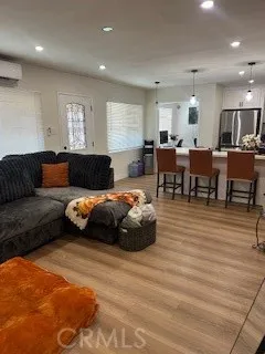 a living room with furniture a wooden floor and chandelier