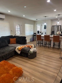 23435 Panama Avenue Carson, CA 90745 - Photo 4 of 22 a living room with furniture a wooden floor and chandelier