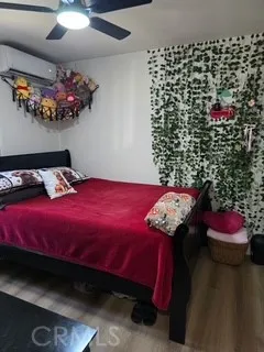 a bedroom with a bed and a potted plant