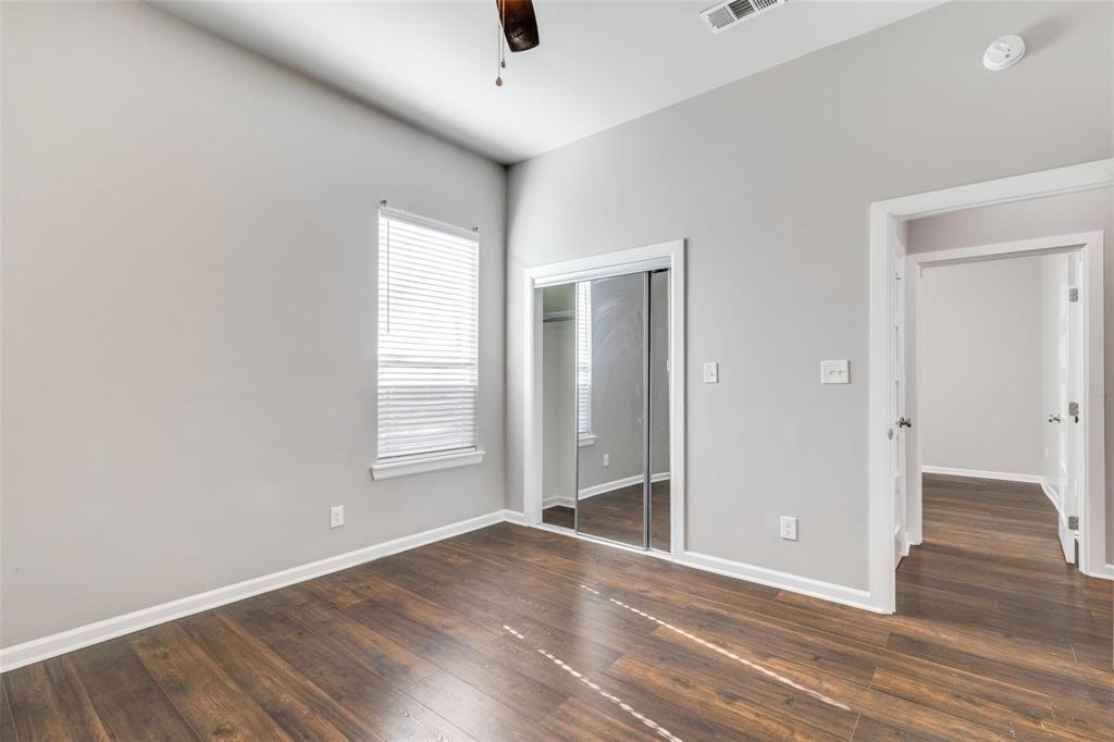 619 Buckalew Street Dallas, TX 75208 - Photo 14 of 29 an empty room with wooden floor and window